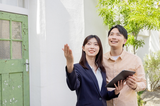不動産担当者が物件を案内するカップル